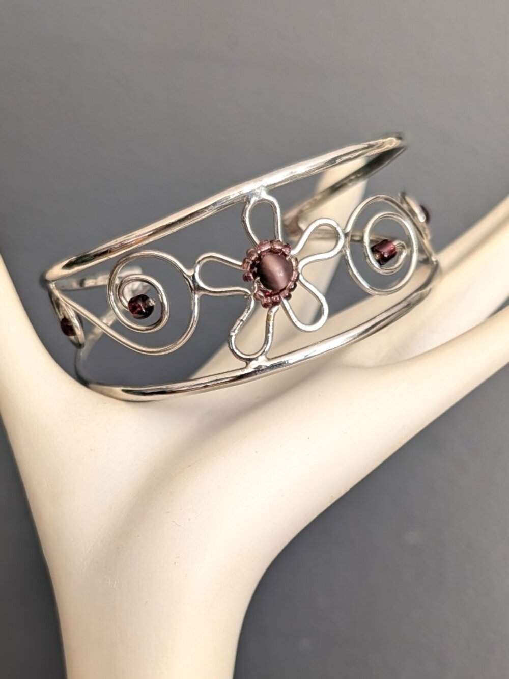 Silver tone cuff bracelet with purple beads
